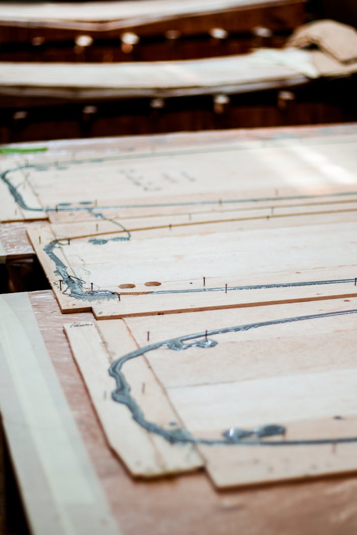 Close-up view of wooden crafting patterns in a workshop, highlighting detailed design work.