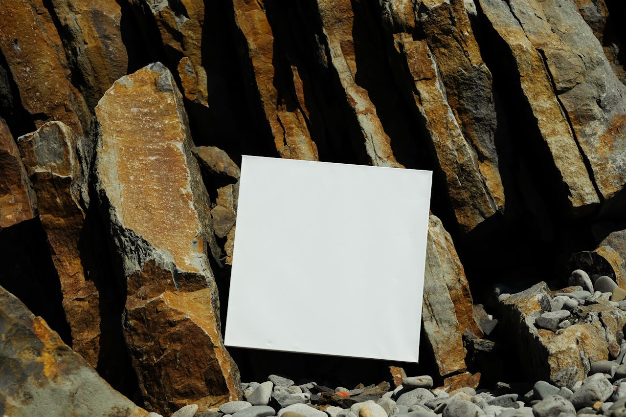 White canvas leaning against rugged rock formations, ideal for mockups.